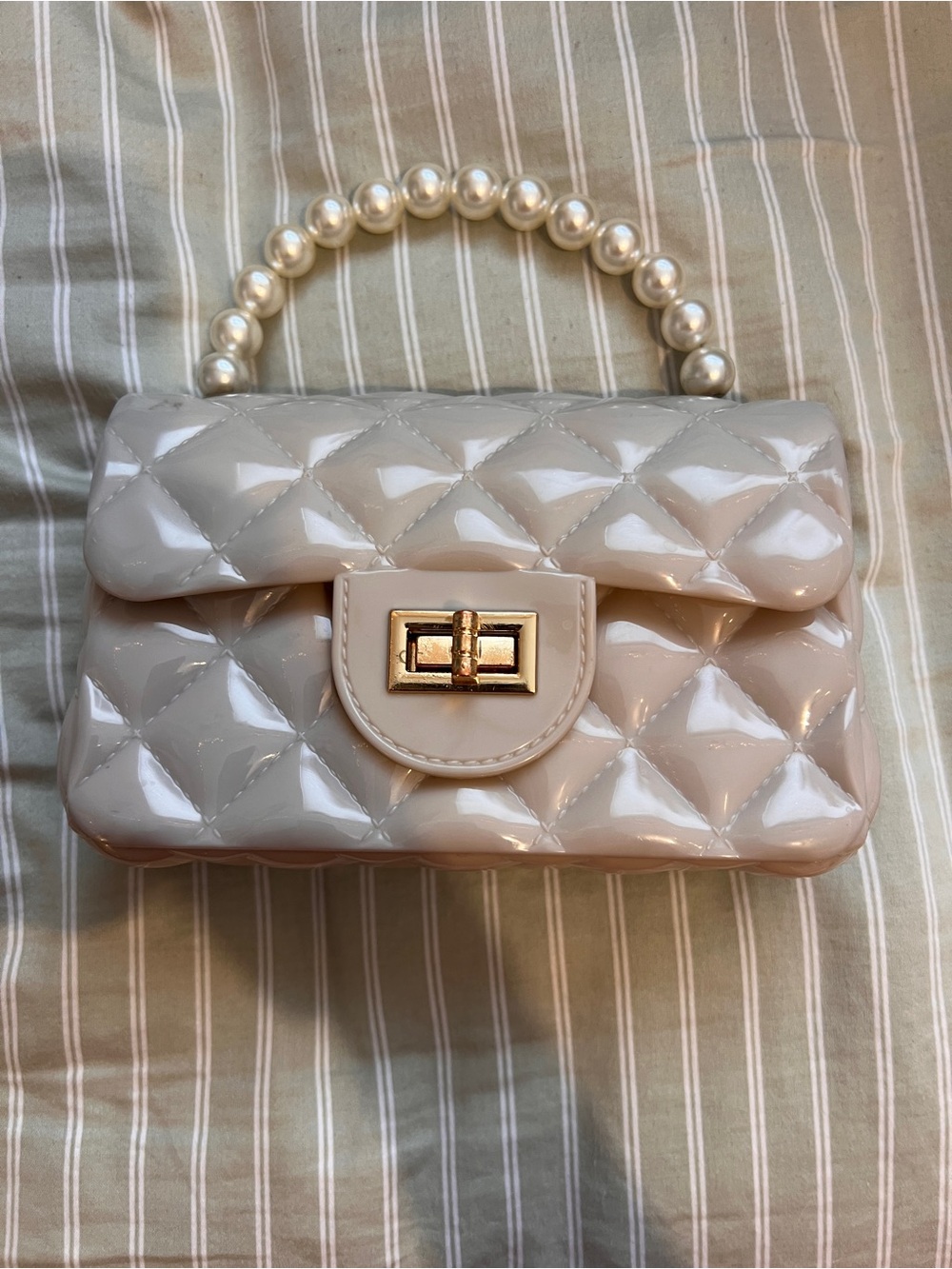 Pink quilted plastic design handbag with pearl handle